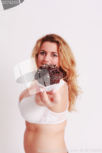 Image of Woman presenting a muffin chocolate