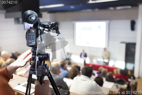 Image of Television broadcasted press conference.