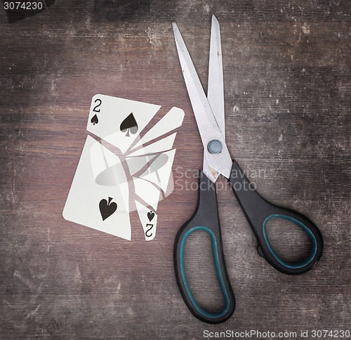 Image of Concept of addiction, card with scissors