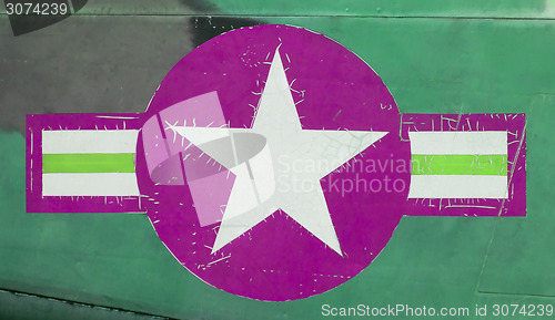 Image of Tail of Vietnam war Airplane, green and pink