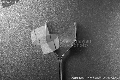 Image of Wine glass made of forks on black