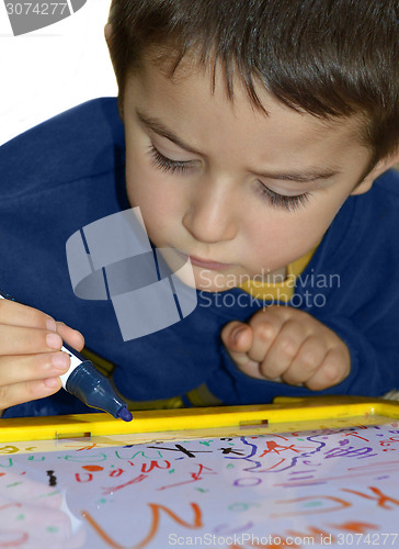 Image of Young boy write