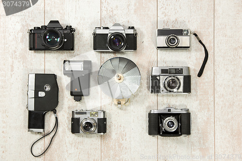 Image of Vintage Cameras With Flash On Floorboard