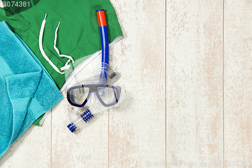 Image of Swimming Trunks, Towel And Snorkeling Mask On Floorboard