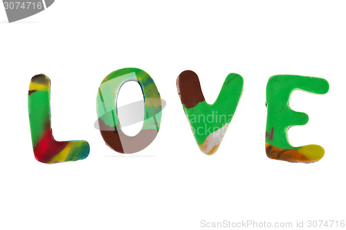 Image of Plasticine letters forming word LOVE written on white background