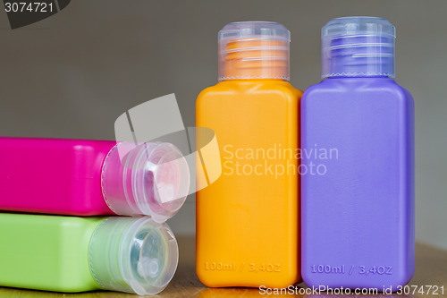 Image of Small colored plastic bottles for traveling