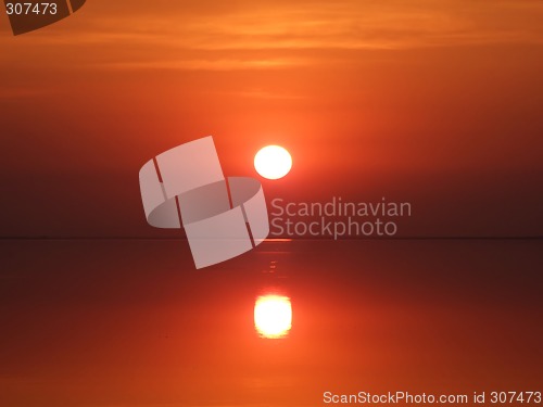 Image of Red sunset above a serene gulf