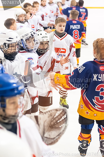Image of Child hockey. Greeting of players after game