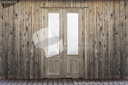 Image of door with frosty window of plank house