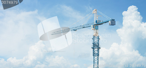 Image of Tall Construction Crane Stands Against a Cloudy Sky