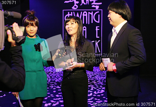 Image of Korean fashion designer Hwang Jae Bock (middle) is interviewed b