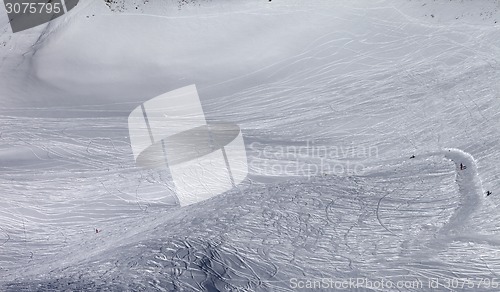 Image of Skiers and snowboarders on off-piste slope in sun day