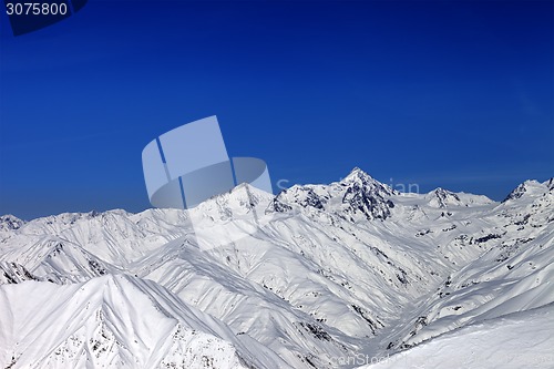 Image of Snowy mountain peaks in sun day
