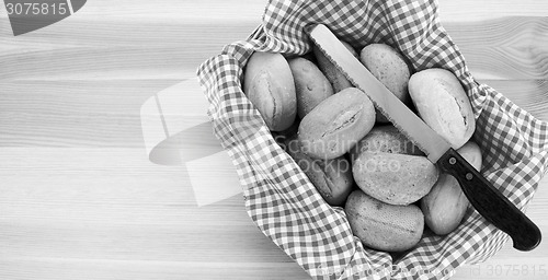 Image of Basket of petit pain and a bread knife 