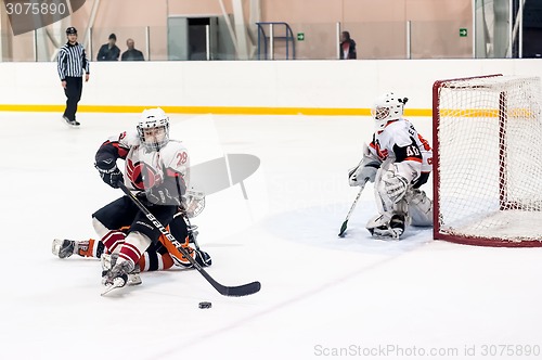 Image of Attack in game between children ice-hockey teams