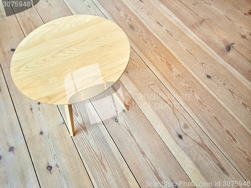 Image of Simple round table on wooden floor