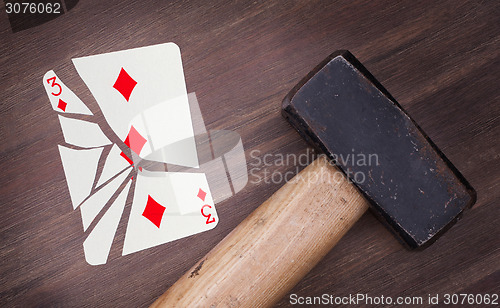 Image of Hammer with a broken card, three of diamonds