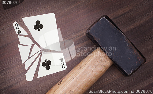 Image of Hammer with a broken card, two of clubs