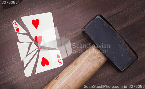 Image of Hammer with a broken card, three of hearts