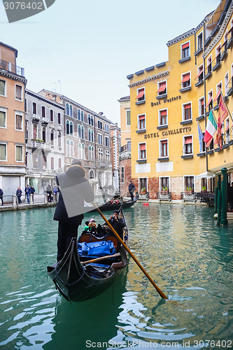 Image of Gondola with tourists in water canal