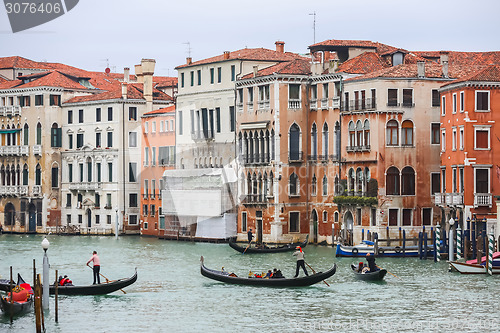 Image of Gondolas sailing through water canal in Venice