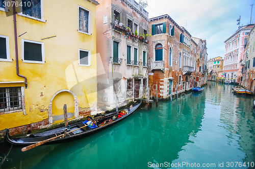 Image of Gondolas parked next to houses in water canal