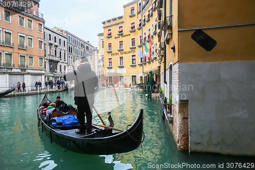 Image of Gondola with tourists in Venice