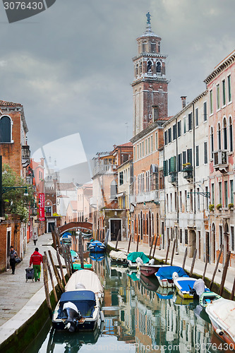 Image of Gondolas moored along water canal in Venice