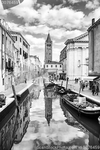 Image of Gondolas moored along water canal in Venice bw