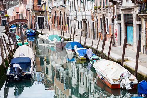 Image of Empty gondolas moored along water canal