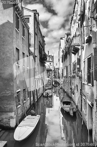 Image of Gondolas parked in water canal bw