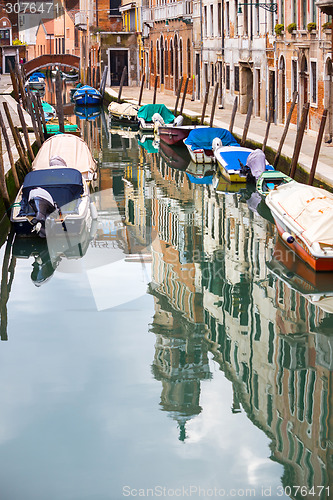 Image of Empty gondolas moored in water canal