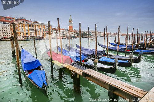 Image of Moored gondolas at dock in Venice