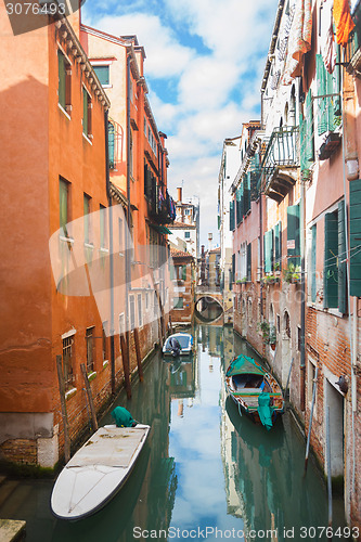 Image of Gondolas parked next to buildings in water canal