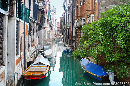 Image of Gondolas parked in front of buildings in water canal