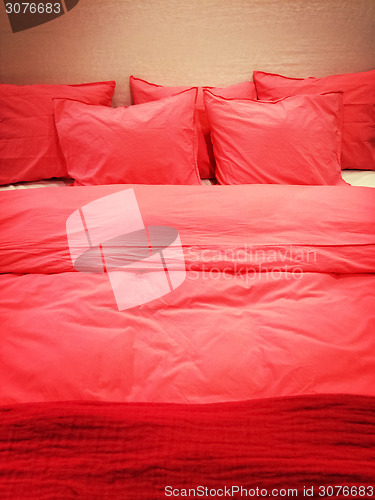 Image of Bed with red romantic bed linen