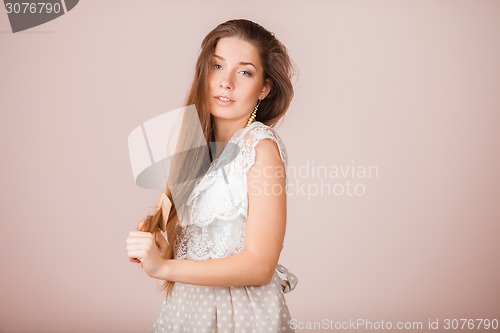 Image of Smiling Girl combs her hair