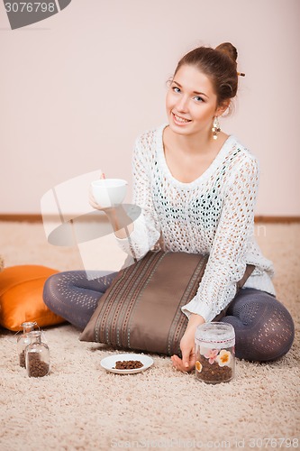 Image of Smiling Woman with cup of coffee