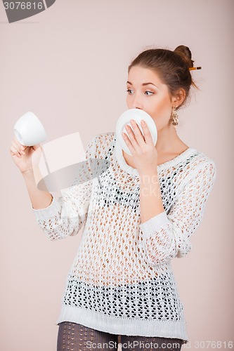 Image of Suprised Woman with cup and saucer