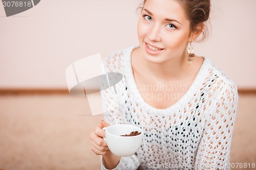 Image of Smiling Woman with cup of coffee