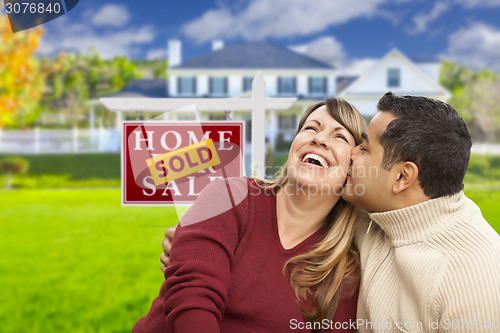 Image of Mixed Race Couple in Front of Sold Real Estate Sign