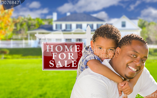 Image of Father and Son In Front of Sale Sign and House