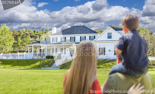 Image of Mixed Race Young Family Looking At Beautiful Home