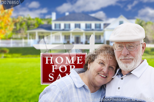 Image of Happy Senior Couple Front of For Sale Sign and House