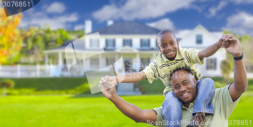 Image of Playful African American Father and Son In Front of Home