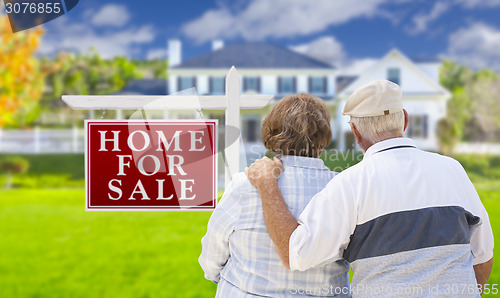 Image of Happy Senior Couple Front of For Sale Sign and House