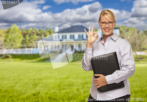 Image of Attractive Businesswoman In Front of Nice Residential Home