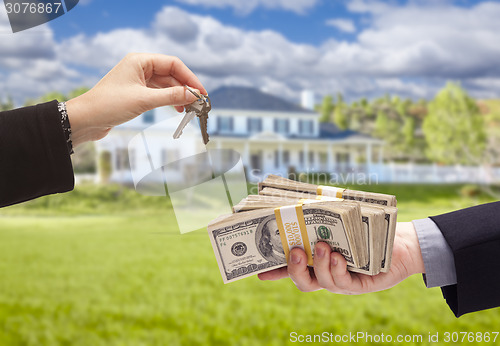 Image of Handing Over Cash For House Keys in Front of Home