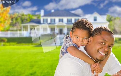 Image of Mixed Race Father and Son In Front of House