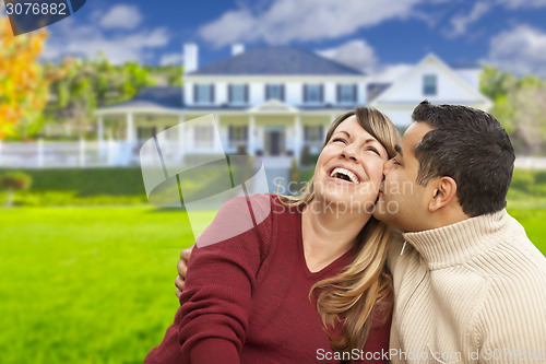 Image of Happy Mixed Race Couple in Front of House